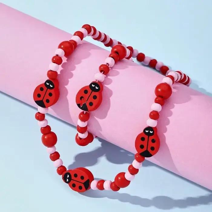 Ensembles de collier et bracelet CÔTÉ cinelle rouge pour filles, perles en bois naturel, motif de de